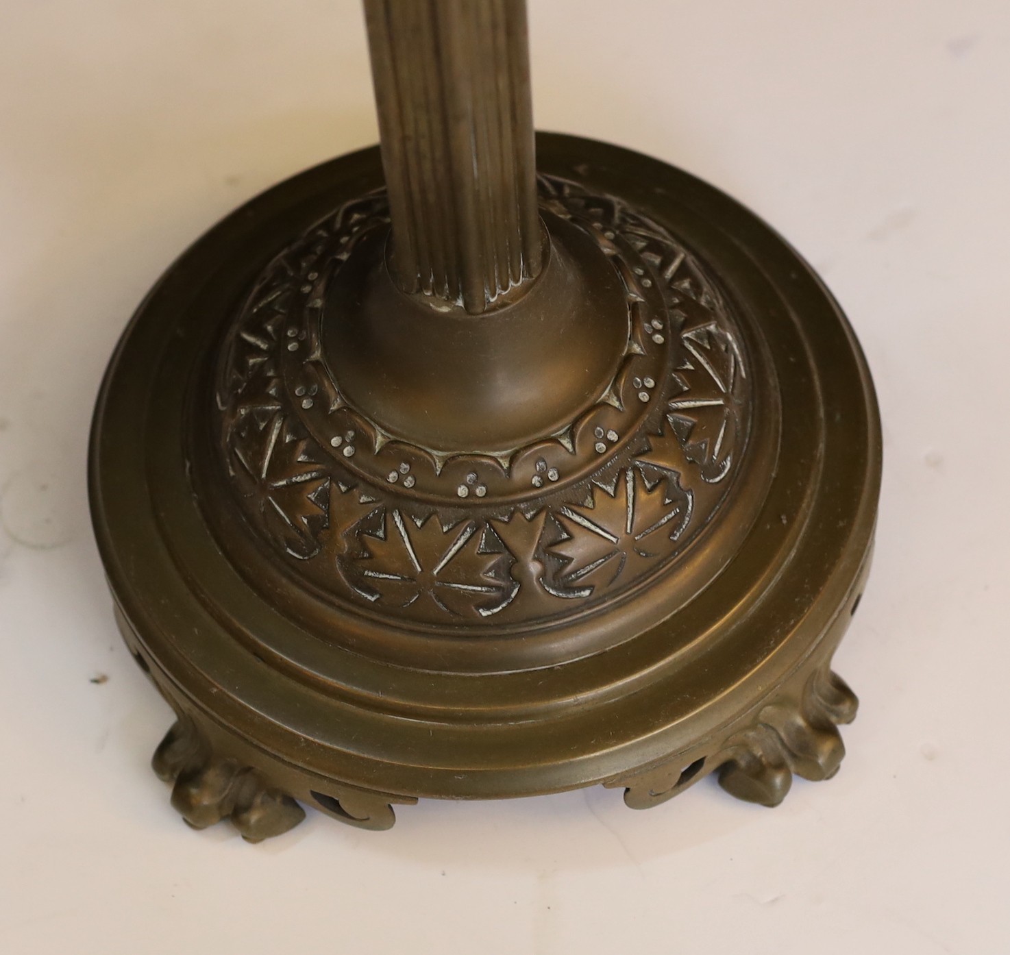 A Victorian brass oil lamp with opaque yellow glass reservoir, duplex mechanism, etched glass globe and flue, height overall 72cm